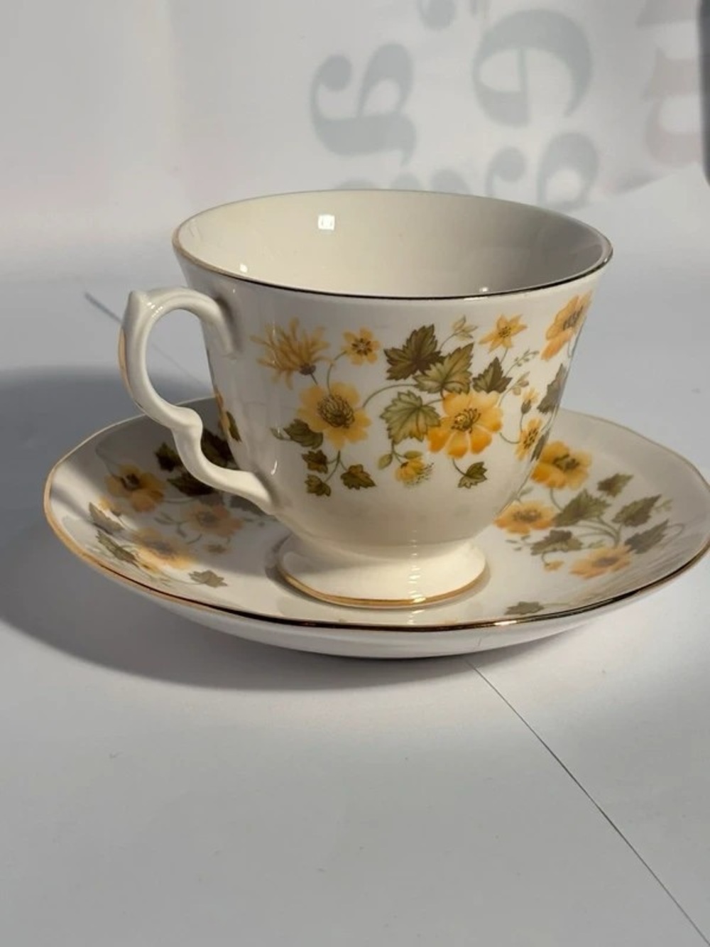 Cream Porcelain Tea Cup & Saucer with Yellow Floral Motif